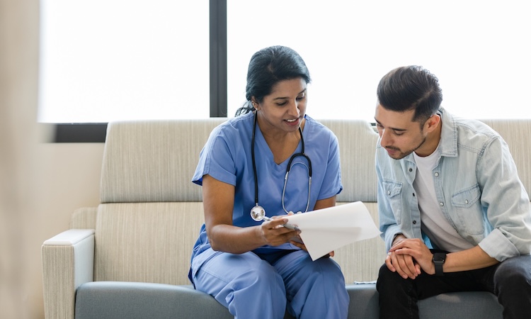 A health care worker discusses next steps with a patient.