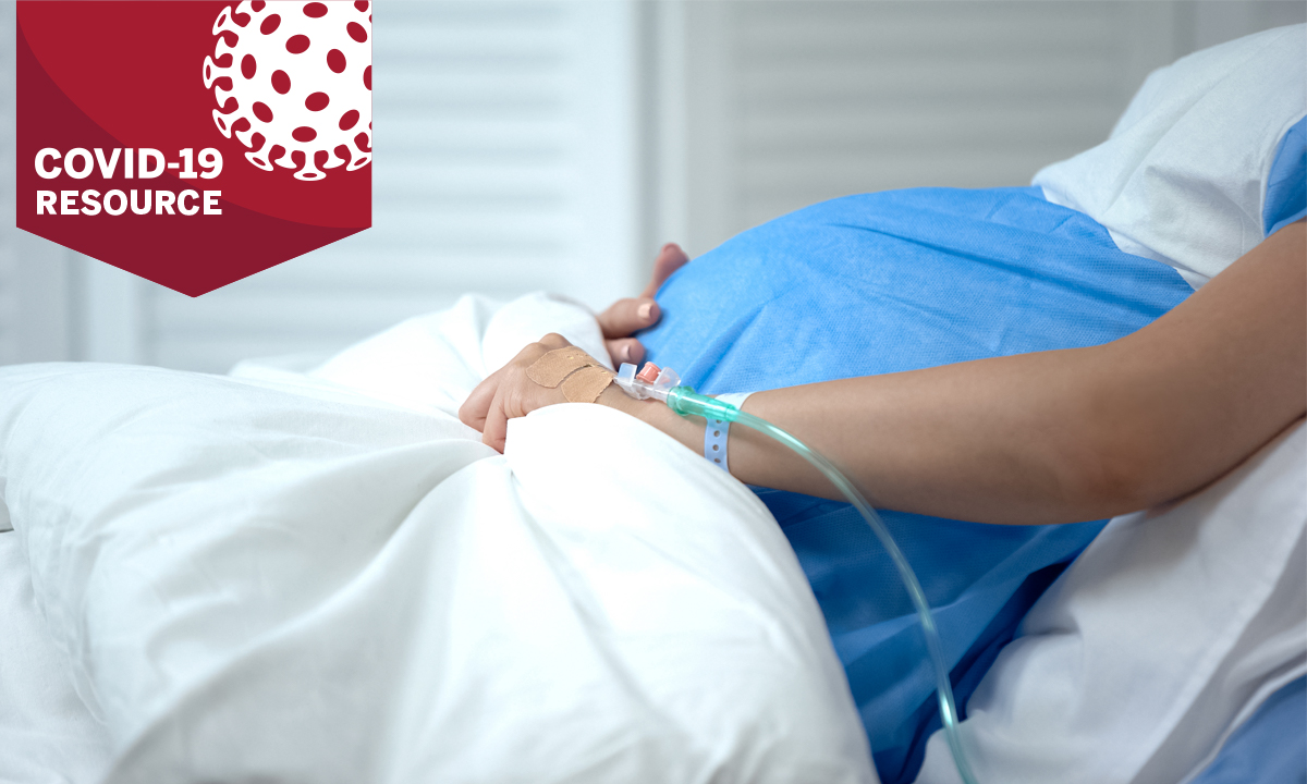 Pregnant woman holding blanket in hospital